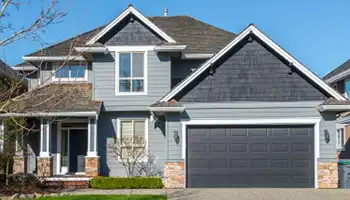 Two-story house with garage in neighborhood