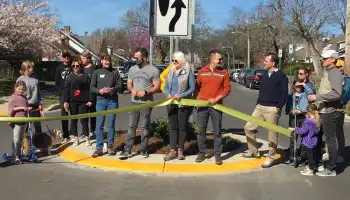 Neighborhood group cutting ribbon on neighborhood traffic calming project