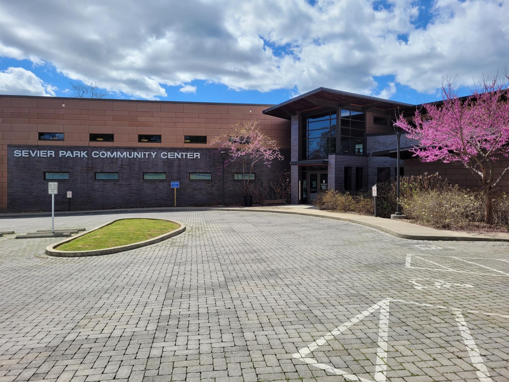 Front of community center with budding plants