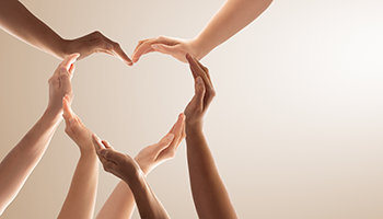 the hands of several people forming a heart shape