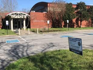 Photo of the outside of Hermitage Precinct with a sign reminding the viewer to lock car doors and remove valuables.