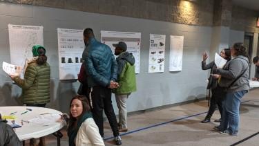 Residents chatting with planners and looking at maps