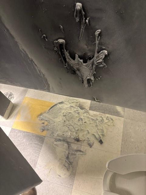 An image depicting the aftermath of a fire started in a school restroom