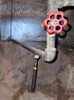 Metal pipe with valve showing magnet attached indicating that it is galvanized