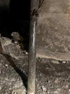 Metal pipe showing shiny scratch marks indicating that it is a lead pipe
