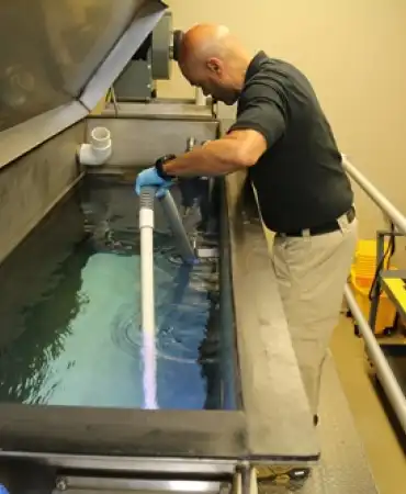 Retrieving a bullet from the water tank.