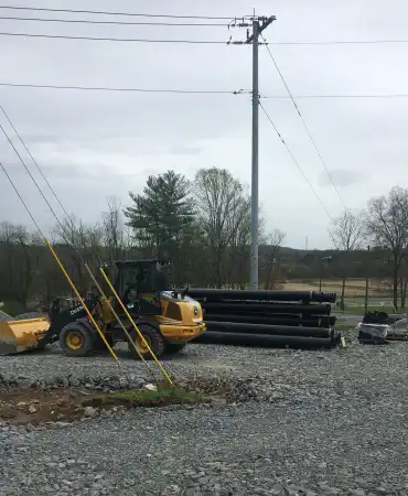 Water line materials and heavy machinery used to excavate and fill